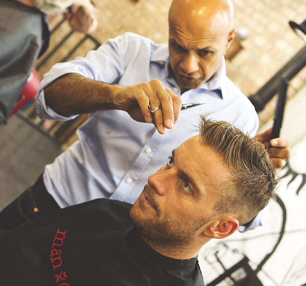Professional barber cutting hair